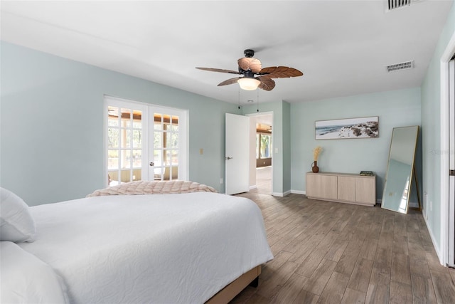 900 NW Snug Harbor Rd, Crystal River, FL 34428 - bedroom with wood finished floors and a ceiling fan