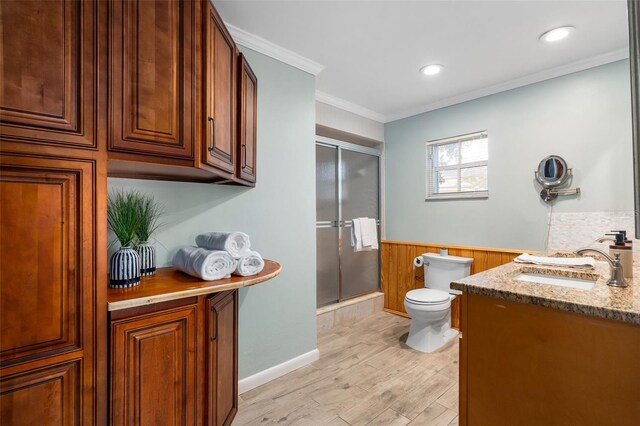 900 NW Snug Harbor Rd, Crystal River, FL 34428 - bathroom featuring vanity, a shower with shower door, wainscoting, wood finished floors, and wood walls
