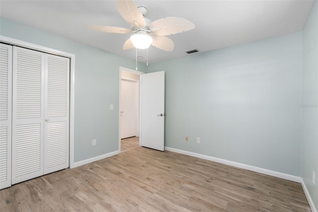 900 NW Snug Harbor Rd, Crystal River, FL 34428 - unfurnished bedroom with a closet, light wood-style flooring, and a ceiling fan
