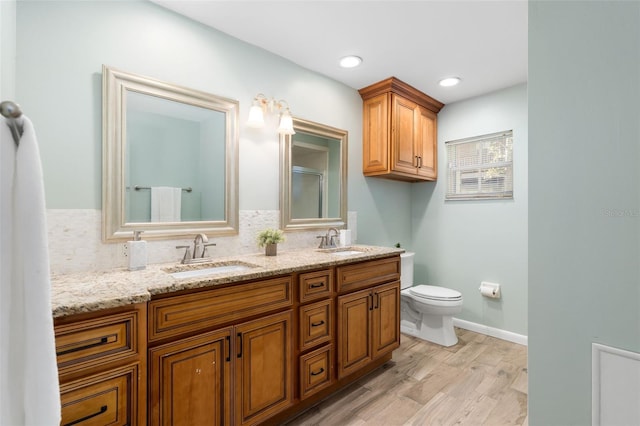 900 NW Snug Harbor Rd, Crystal River, FL 34428 - full bathroom featuring double vanity, wood finished floors, tasteful backsplash, and a shower