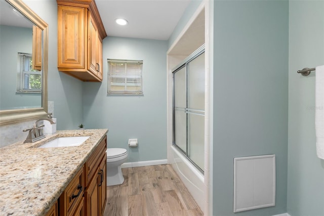 900 NW Snug Harbor Rd, Crystal River, FL 34428 - full bath with vanity, wood finished floors, bath / shower combo with glass door, and recessed lighting