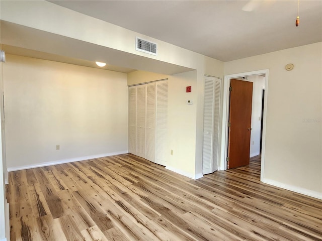 2360 SW Archer Rd Unit 208, Gainesville, FL 32608 - unfurnished bedroom featuring wood finished floors and baseboards