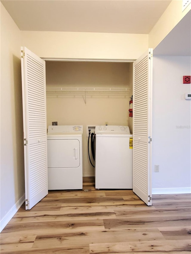 2360 SW Archer Rd Unit 208, Gainesville, FL 32608 - laundry room featuring independent washer and dryer and light wood finished floors