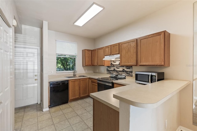 3901 SW 20th Ave Unit 806, Gainesville, FL 32607 - kitchen featuring appliances with stainless steel finishes, under cabinet range hood, light countertops, a peninsula, and brown cabinets