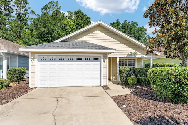 11752 NW 61st Ter, Alachua, FL 32615 - ranch-style house with driveway, an attached garage, and a shingled roof