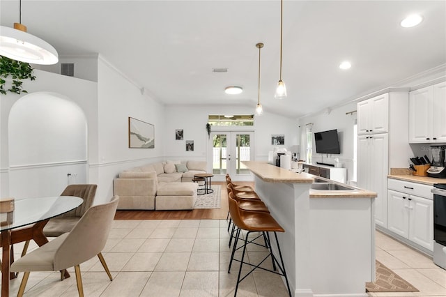 11752 NW 61st Ter, Alachua, FL 32615 - kitchen featuring french doors, open floor plan, light tile patterned floors, light countertops, and recessed lighting