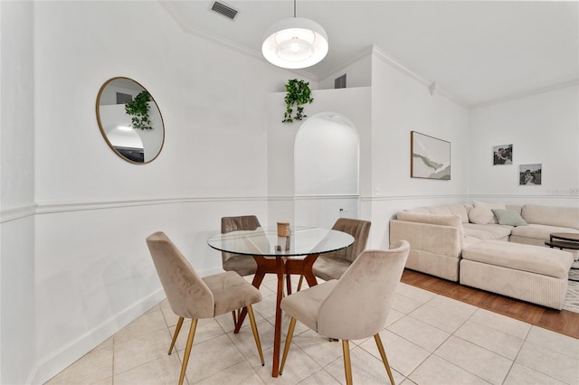 11752 NW 61st Ter, Alachua, FL 32615 - tiled dining space with crown molding and baseboards