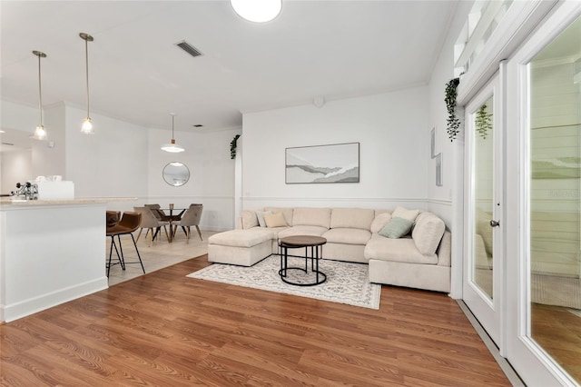 11752 NW 61st Ter, Alachua, FL 32615 - living room with light wood-style floors and crown molding