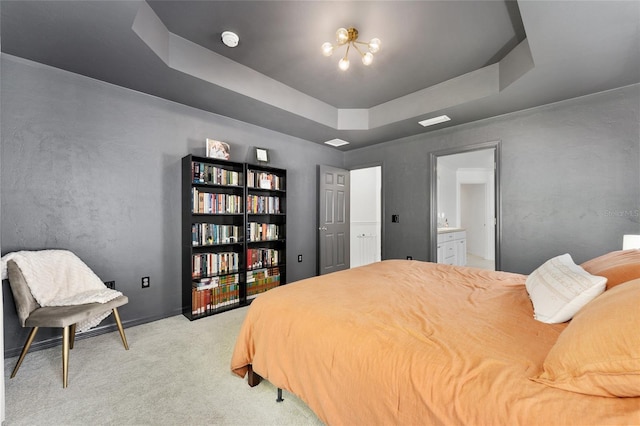 11752 NW 61st Ter, Alachua, FL 32615 - bedroom featuring a raised ceiling, light colored carpet, ensuite bath, and a chandelier