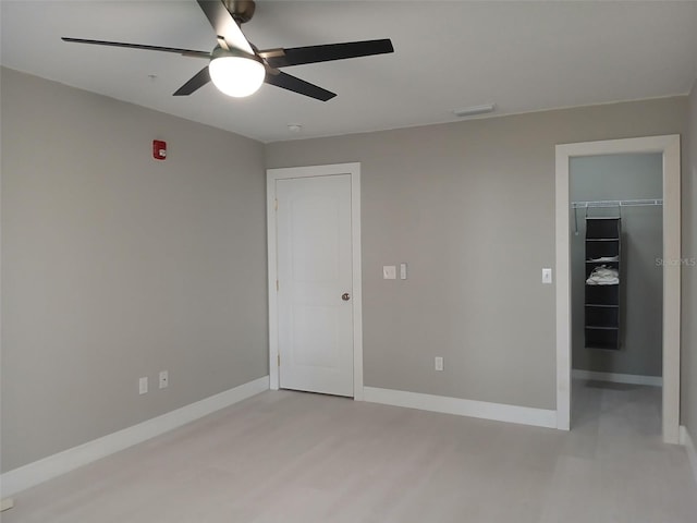 6519 W Newberry Rd Unit 404, Gainesville, FL 32605 - unfurnished bedroom featuring a walk in closet, a closet, and a ceiling fan