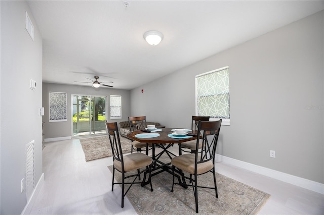 6519 W Newberry Rd Unit 404, Gainesville, FL 32605 - dining area featuring baseboards and a ceiling fan