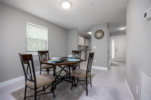 6519 W Newberry Rd Unit 404, Gainesville, FL 32605 - dining room featuring light wood finished floors