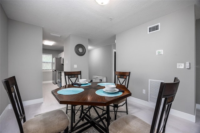 6519 W Newberry Rd Unit 404, Gainesville, FL 32605 - dining space with a textured ceiling