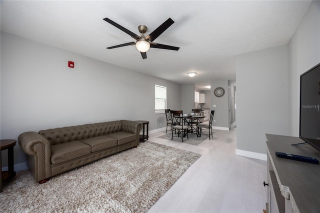 6519 W Newberry Rd Unit 404, Gainesville, FL 32605 - living area featuring wood finished floors and a ceiling fan