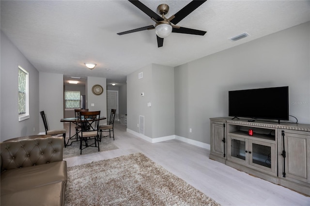 6519 W Newberry Rd Unit 404, Gainesville, FL 32605 - living area with ceiling fan and light wood-type flooring