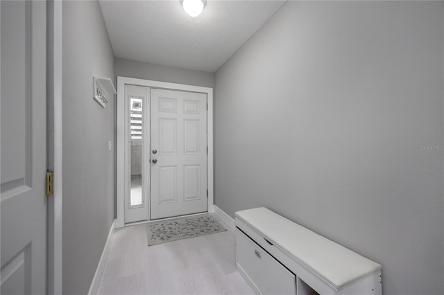 6519 W Newberry Rd Unit 404, Gainesville, FL 32605 - entryway with light wood finished floors and a textured ceiling