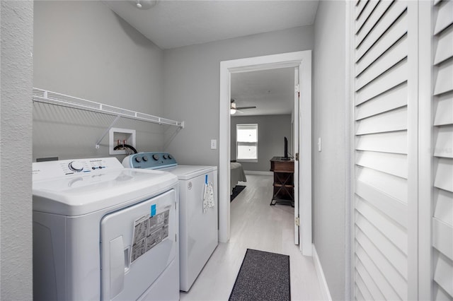 6519 W Newberry Rd Unit 404, Gainesville, FL 32605 - laundry area with independent washer and dryer, ceiling fan, and light wood-type flooring