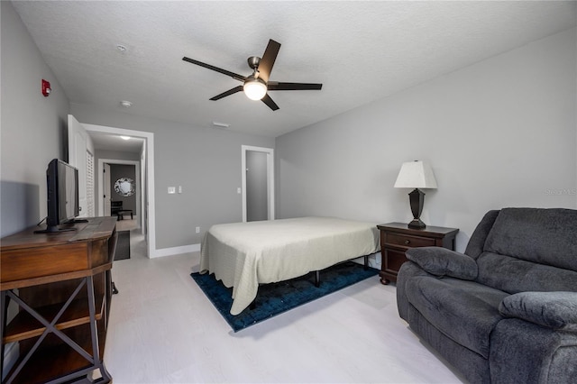 6519 W Newberry Rd Unit 404, Gainesville, FL 32605 - bedroom featuring a ceiling fan and a textured ceiling