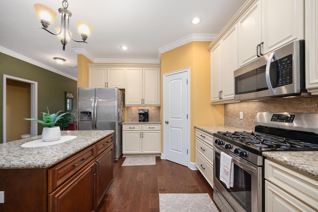 7827 SW 79th Dr, Gainesville, FL 32608 - kitchen with stainless steel appliances, crown molding, dark wood-type flooring, decorative light fixtures, and a chandelier