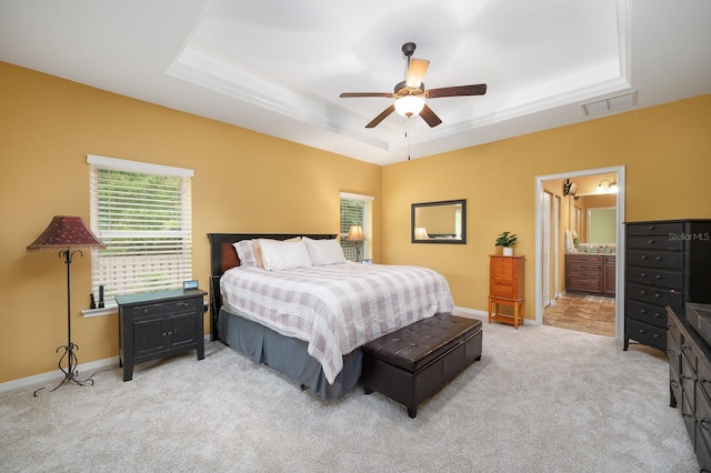 7827 SW 79th Dr, Gainesville, FL 32608 - bedroom with a raised ceiling, multiple windows, light carpet, and a ceiling fan