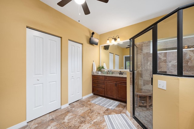 7827 SW 79th Dr, Gainesville, FL 32608 - bathroom featuring vanity, a stall shower, a ceiling fan, and stone finish floors