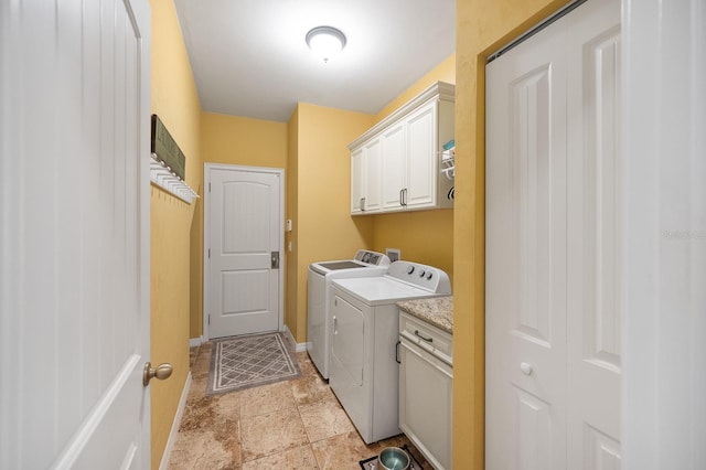 7827 SW 79th Dr, Gainesville, FL 32608 - washroom with cabinet space, washing machine and clothes dryer, and light stone finish flooring