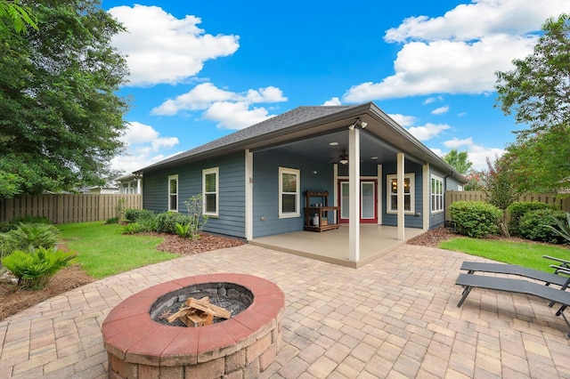 7827 SW 79th Dr, Gainesville, FL 32608 - back of house featuring an outdoor fire pit, ceiling fan, a fenced backyard, and a patio