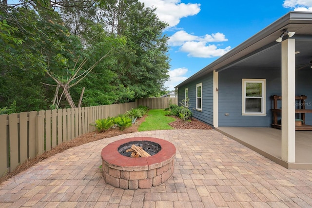7827 SW 79th Dr, Gainesville, FL 32608 - fenced backyard with an outdoor fire pit and a patio area