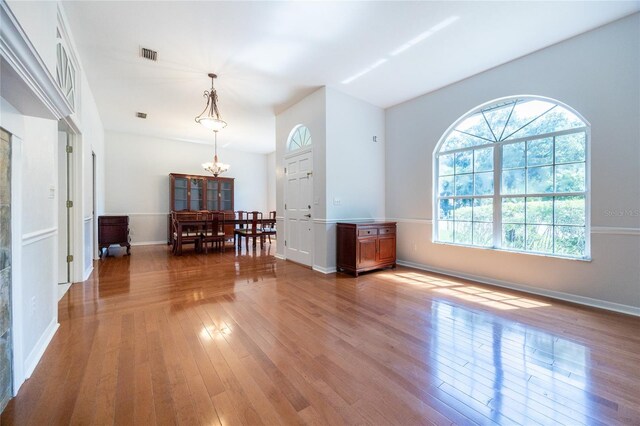 2013 SW 76th Ter, Gainesville, FL 32607 - living room with a chandelier and hardwood / wood-style floors