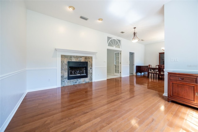 2013 SW 76th Ter, Gainesville, FL 32607 - living area with light wood-type flooring, a tile fireplace, and french doors