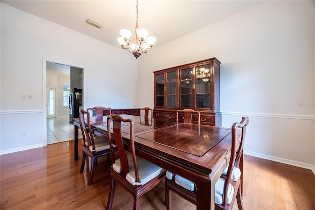 2013 SW 76th Ter, Gainesville, FL 32607 - dining area featuring a chandelier and light wood finished floors