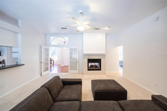 2013 SW 76th Ter, Gainesville, FL 32607 - living area with light carpet, ceiling fan, french doors, and a tile fireplace