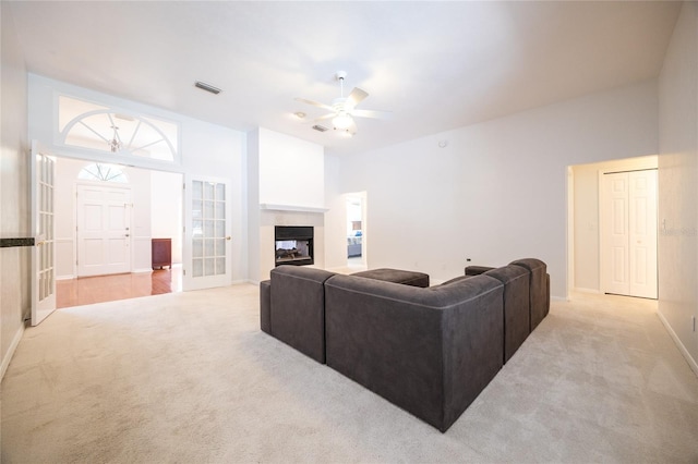 2013 SW 76th Ter, Gainesville, FL 32607 - living area featuring light colored carpet, a ceiling fan, and a multi sided fireplace
