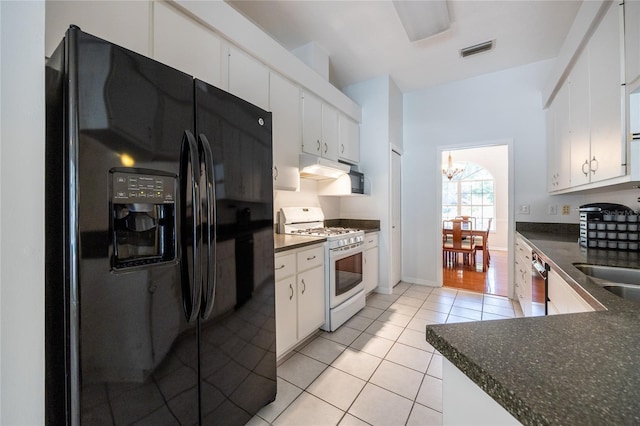 2013 SW 76th Ter, Gainesville, FL 32607 - kitchen with black fridge, white gas range oven, dark countertops, light tile patterned floors, and a chandelier
