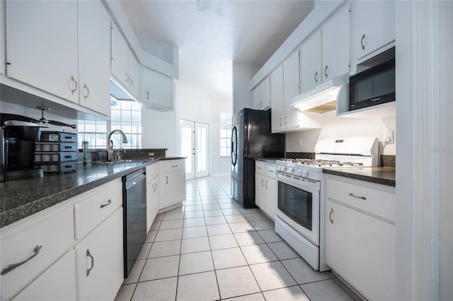 2013 SW 76th Ter, Gainesville, FL 32607 - kitchen with white gas range, under cabinet range hood, dark countertops, dishwasher, and light tile patterned floors