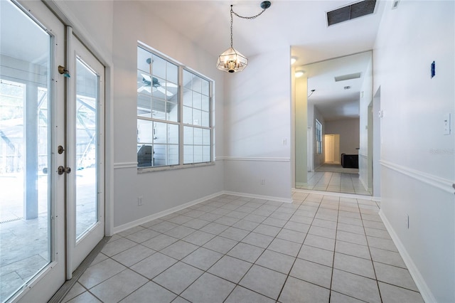 2013 SW 76th Ter, Gainesville, FL 32607 - unfurnished dining area with plenty of natural light and light tile patterned floors