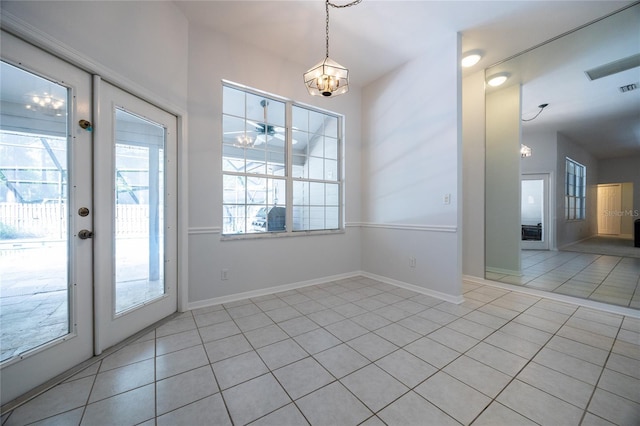 2013 SW 76th Ter, Gainesville, FL 32607 - unfurnished dining area with light tile patterned floors and a chandelier
