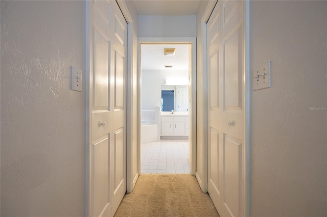 2013 SW 76th Ter, Gainesville, FL 32607 - hallway with light carpet and light tile patterned flooring