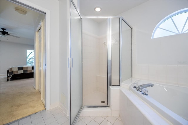 2013 SW 76th Ter, Gainesville, FL 32607 - ensuite bathroom with a shower stall, a garden tub, tile patterned flooring, and a ceiling fan