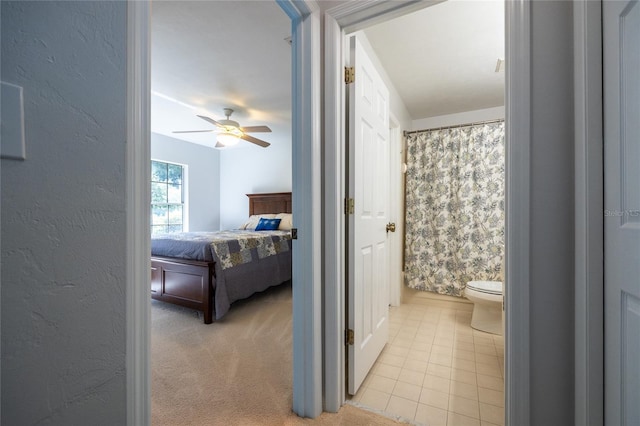 2013 SW 76th Ter, Gainesville, FL 32607 - full bath featuring a ceiling fan, tile patterned flooring, connected bathroom, and curtained shower