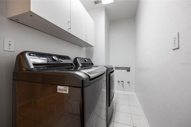 2013 SW 76th Ter, Gainesville, FL 32607 - washroom featuring cabinet space, washer and clothes dryer, and light tile patterned floors