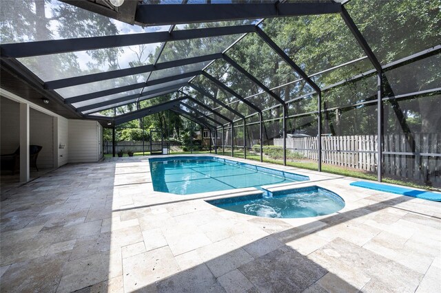 2013 SW 76th Ter, Gainesville, FL 32607 - view of swimming pool featuring a patio area, a fenced backyard, a pool with connected hot tub, and glass enclosure