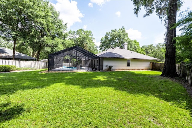 2013 SW 76th Ter, Gainesville, FL 32607 - rear view of house featuring a fenced backyard, a chimney, and a lanai