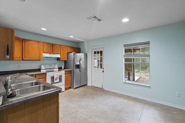 350 Hardee St, Bronson, FL 32621 - kitchen with electric stove, stainless steel fridge with ice dispenser, under cabinet range hood, plenty of natural light, and recessed lighting