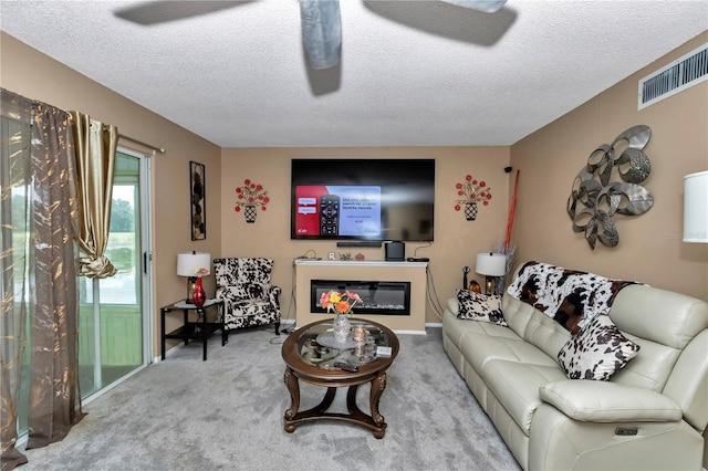 487 Midway Dr Unit B, Ocala, FL 34472 - living room with a textured ceiling, carpet floors, and a glass covered fireplace