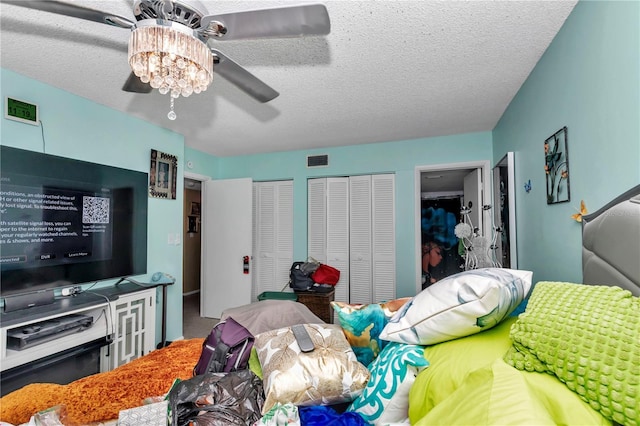 487 Midway Dr Unit B, Ocala, FL 34472 - bedroom with a textured ceiling, two closets, and a ceiling fan