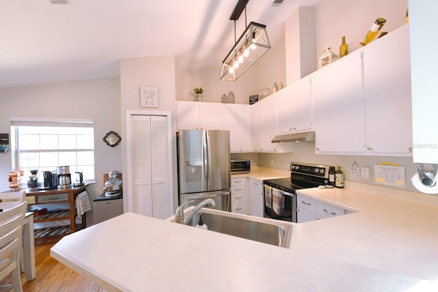 3735 NW 64th Pl, Gainesville, FL 32653 - kitchen featuring appliances with stainless steel finishes, under cabinet range hood, light countertops, light wood-style floors, and white cabinetry