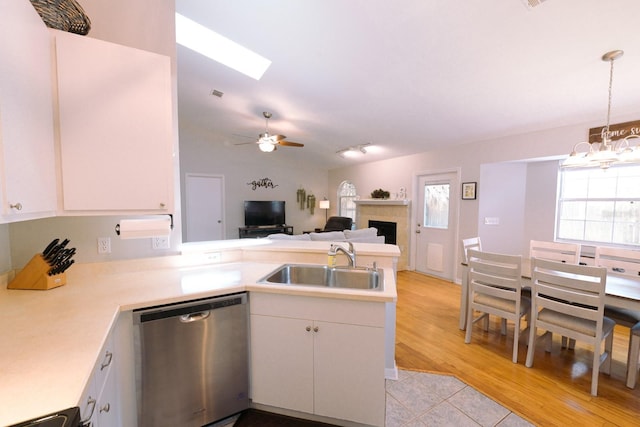 3735 NW 64th Pl, Gainesville, FL 32653 - kitchen with dishwasher, a peninsula, lofted ceiling, light countertops, and a chandelier