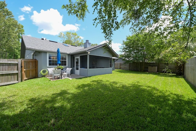 3735 NW 64th Pl, Gainesville, FL 32653 - rear view of property with a chimney, a sunroom, a fenced backyard, and a patio