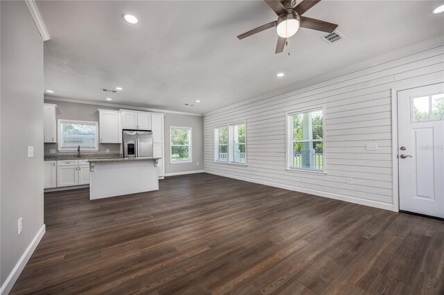 16011 S County Road 325, Hawthorne, FL 32640 - unfurnished living room with ornamental molding, ceiling fan, recessed lighting, dark wood finished floors, and wooden walls